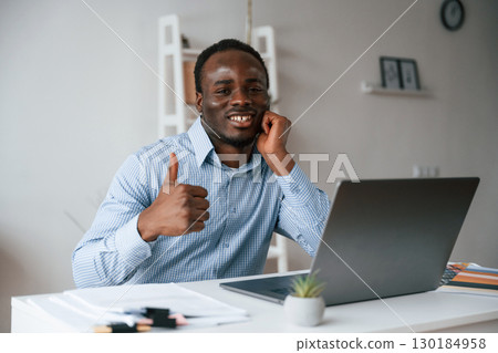 Front view. Businessman is working in the office by laptop 130184958