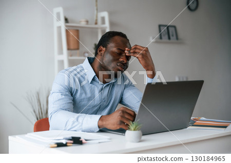 Feeling bad, stressful. Businessman is working in the office by laptop Feeling bad, stressful. Businessman is working in the office by laptop 130184965