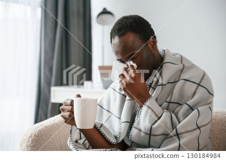 Terrible flu. Sick black man is at home 130184984