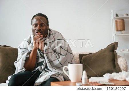 Pain in the throat. Sick black man is at home Pain in the throat. Sick black man is at home 130184997