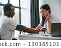 Healthcare conception. Female doctor measures blood pressure of a man 130185101