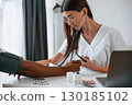 Healthcare conception. Female doctor measures blood pressure of a man 130185102