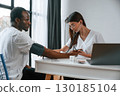 Healthcare conception. Female doctor measures blood pressure of a man 130185104