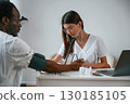 Healthcare conception. Female doctor measures blood pressure of a man 130185105