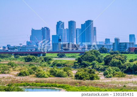 Tokyo cityscape in Japan on August 19th...View of the Tama River and tower apartment complexes in front of Kawasaki and Musashi-Kosugi stations = Reiwa 7 130185431