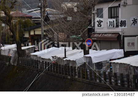Takayama City, Gifu Prefecture, Japan - Miyagawa Morning Market, a tourist attraction, with stalls selling local specialties and a shopping street - morning scene during the Takayama Festival 130185487