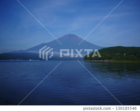 Summer clouds seen from Lake Yamanaka, with the blue Mount Fuji towering over it. Copy space 130185546