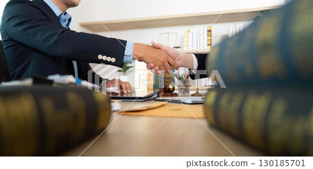 Business Deal. Lawyers shaking hands after a successful agreement. 130185701