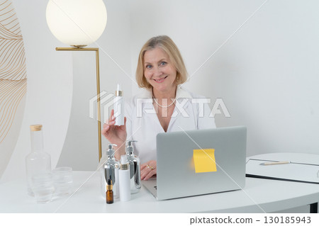 A Professional Woman Surrounded by Skincare Products Inside a Contemporary Modern Workspace 130185943