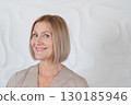 Senior woman sitting in front of mirror at home 130185946