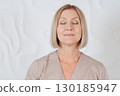 Senior woman sitting in front of mirror at home 130185947