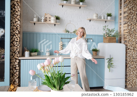 Healthy Lifestyle A Woman Delightfully Enjoying her life a Modern and Stylish Kitchen Space 130185962