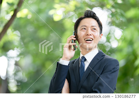Business man, fresh greenery, smartphone, call 130186277