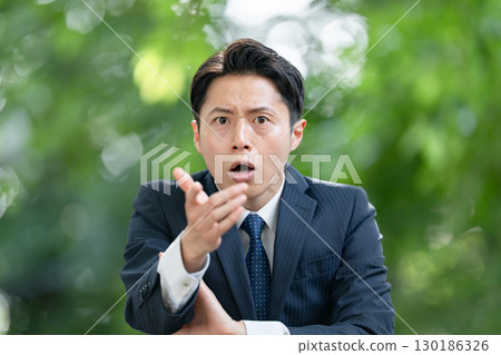 Business man surprised by fresh greenery Business man surprised by fresh greenery 130186326