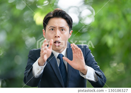 Business man surprised by fresh greenery Business man surprised by fresh greenery 130186327