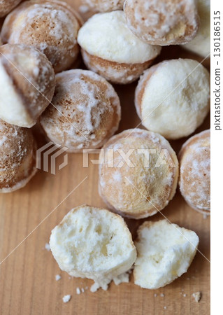 Suzu castella cake torn in half and coated with sugar Suzu castella cake torn in half and coated with sugar 130186515