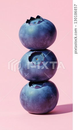 A stack of blueberry fruit balancing on top with pink solid background 130186857