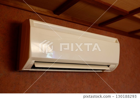 Air conditioner installed on the wall of an old house Air conditioner installed on the wall of an old house 130188293