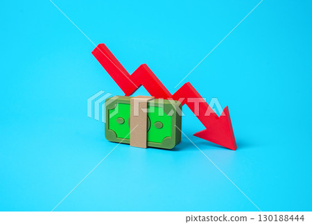 A stack of money and an arrow pointing down. A drop in income, salary cut, financial loss, reduced profits, economic downturn, recession effects, money shortage 130188444