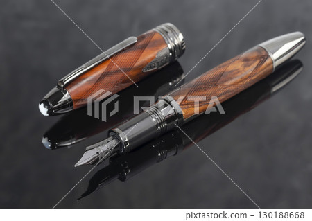 Fountain pen on dark marble background. Rare writing instruments. Fountain pen on dark marble background. Rare writing instruments. 130188668