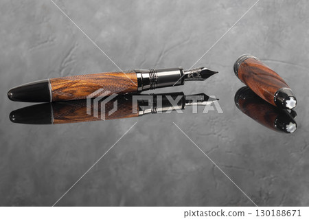 Fountain pen on dark marble background. Rare writing instruments. 130188671