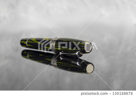 Fountain pen on dark marble background. Rare writing instruments. Fountain pen on dark marble background. Rare writing instruments. 130188678