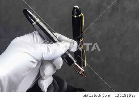 Fountain pen on dark marble background. Rare writing instruments. 130188685