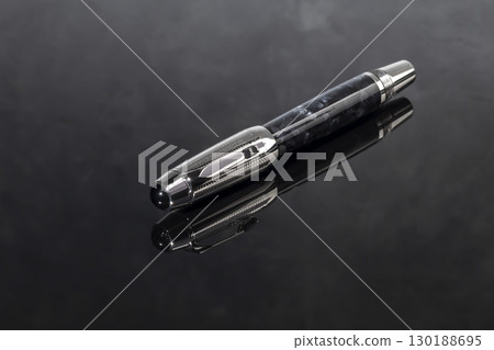 Fountain pen on dark marble background. Rare writing instruments. Fountain pen on dark marble background. Rare writing instruments. 130188695