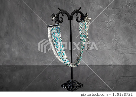 Bracelet and earrings made of beads on a light background. Handmade. Jewelry Bracelet and earrings made of beads on a light background. Handmade. Jewelry 130188721
