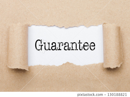 Guarantee text appearing behind torn brown paper Guarantee text appearing behind torn brown paper 130188821