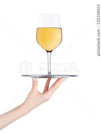 Hand holds tray with white wine glass on white Hand holds tray with white wine glass on white 130188823