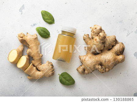 Immune ginger energy shot drink with fresh raw ginger root on light background.Macro. 130188865