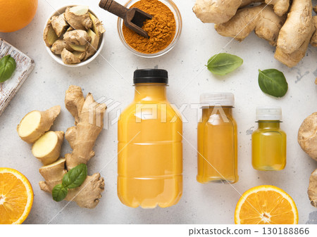 Ginger and orange energy shot immune drink with ginger root and turmeric powder.Top view. 130188866
