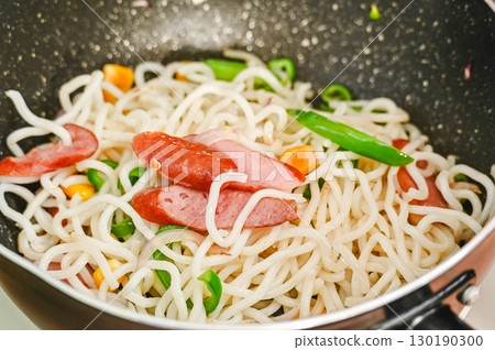 將麵條和食材放入煎鍋翻炒 將麵條和食材放入煎鍋翻炒 130190300