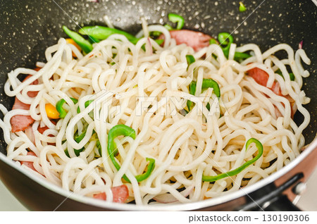 Noodles and ingredients stir-fried in a frying pan Noodles and ingredients stir-fried in a frying pan 130190306