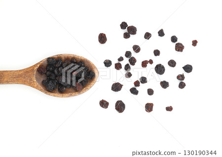 raisins in a spoon isolated on white background. 130190344