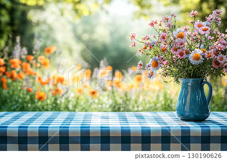 Picnic table with checkered tablecloth and a vase with flowers on a summer background. Retro-style. Mockup. Copy space. Picnic table with checkered tablecloth and a vase with flowers on a summer background. Retro-style. Mockup. Copy space. 130190626