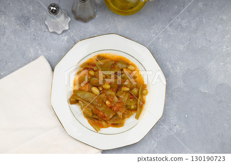 Homemade stewed green beans, tomatoes, garlic with olive oil. Zeytinyagli fasulye traditional food. Turkish cuisine. Homemade stewed green beans, tomatoes, garlic with olive oil. Zeytinyagli fasulye traditional food. Turkish cuisine. 130190723