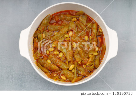 Homemade stewed green beans, tomatoes, garlic with olive oil. Zeytinyagli fasulye traditional food. Turkish cuisine. Homemade stewed green beans, tomatoes, garlic with olive oil. Zeytinyagli fasulye traditional food. Turkish cuisine. 130190733