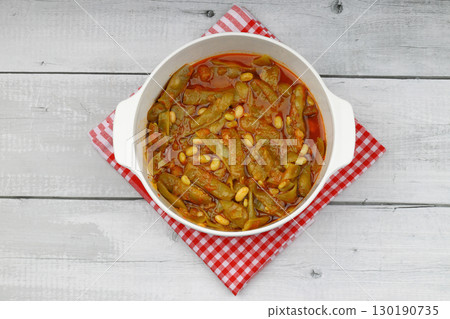 Homemade stewed green beans, tomatoes, garlic with olive oil. Zeytinyagli fasulye traditional food. Turkish cuisine. Homemade stewed green beans, tomatoes, garlic with olive oil. Zeytinyagli fasulye traditional food. Turkish cuisine. 130190735