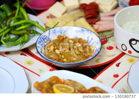 Homemade stewed green beans, tomatoes, garlic with olive oil. Zeytinyagli fasulye traditional food. Turkish cuisine. Homemade stewed green beans, tomatoes, garlic with olive oil. Zeytinyagli fasulye traditional food. Turkish cuisine. 130190737