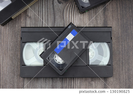 Black VHS video tape cassette with blank label isolated on wooden background Black VHS video tape cassette with blank label isolated on wooden background 130190825