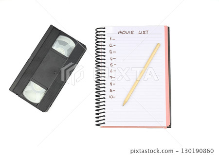 Black VHS video tape cassette with blank label isolated on white background. And empty movie list. 130190860