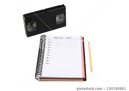 Black VHS video tape cassette with blank label isolated on white background. And empty movie list. 130190861