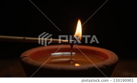 Macro Shot of Spark Igniting Wick on Diya Oil Lamp Moment of Light. Dashahra, India. 130190901