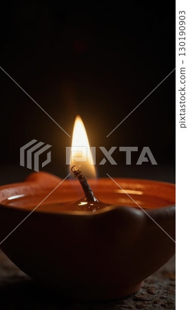Macro Shot of Spark Igniting Wick on Diya Oil Lamp Moment of Light. Dashahra, India. Macro Shot of Spark Igniting Wick on Diya Oil Lamp Moment of Light. Dashahra, India. 130190903