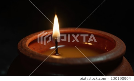 Macro Shot of Spark Igniting Wick on Diya Oil Lamp Moment of Light. Dashahra, India. Macro Shot of Spark Igniting Wick on Diya Oil Lamp Moment of Light. Dashahra, India. 130190904