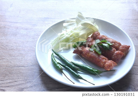 fried Thai north east sausage sfuffing fermenting chop pork and rice eat couple fresh cabbage with chili on plate fried Thai north east sausage sfuffing fermenting chop pork and rice eat couple fresh cabbage with chili on plate 130191031