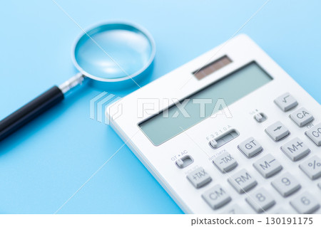 Calculator and magnifying glass Calculator and magnifying glass 130191175