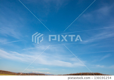 Contrails in the blue sky of late autumn Contrails in the blue sky of late autumn 130191254